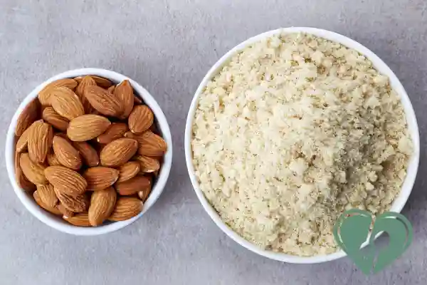 Whole almonds and a bowl of almond flour side by side — a low-carb, diabetic-friendly alternative to traditional flour.