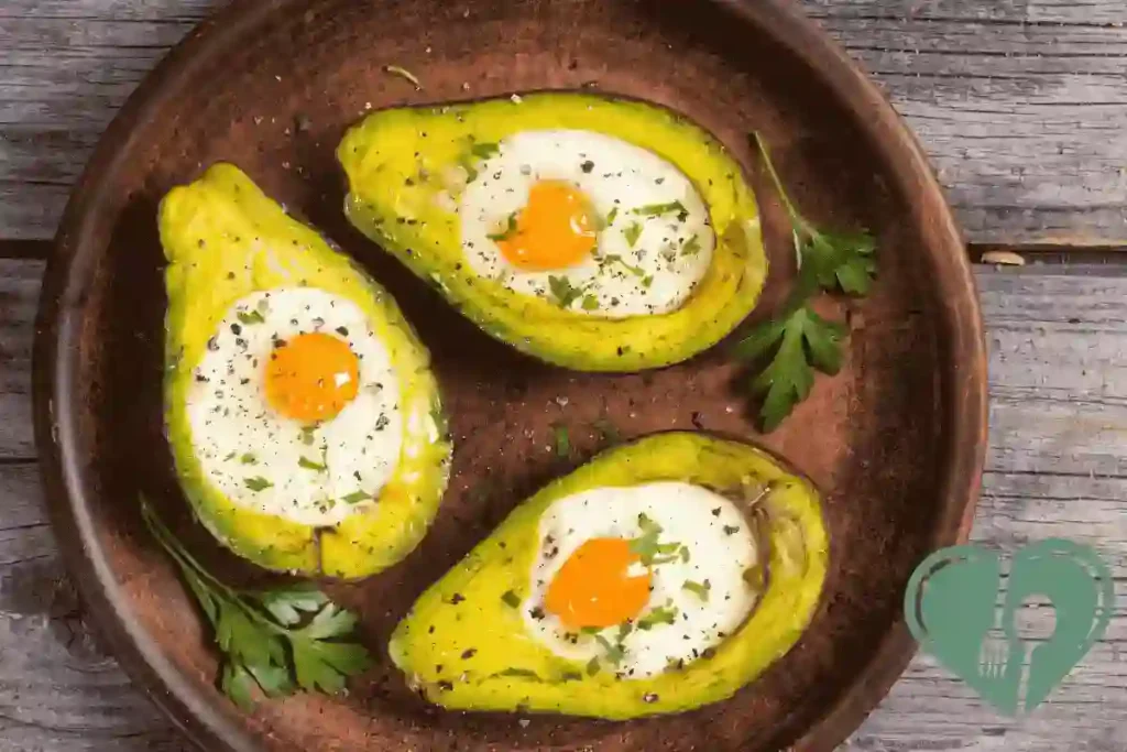 Baked eggs in avocado halves on a wooden plate, garnished with herbs and parsley.