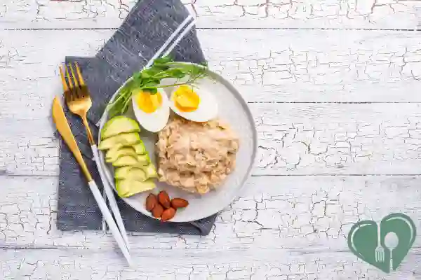 Diabetic-friendly breakfast with eggs, avocado, oatmeal, and almonds