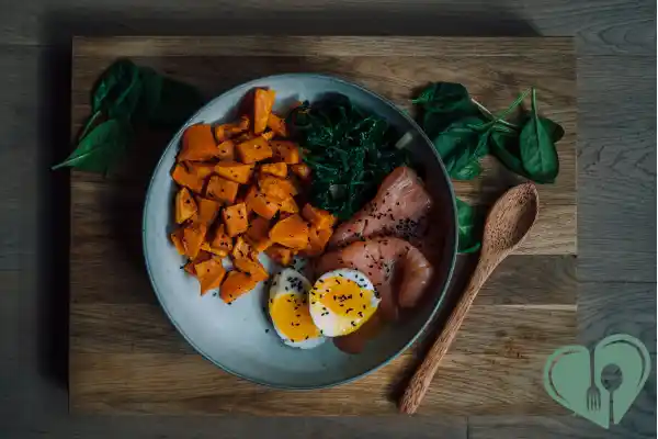 Diabetic-friendly dinner with sweet potatoes, eggs, smoked salmon, and sautéed greens