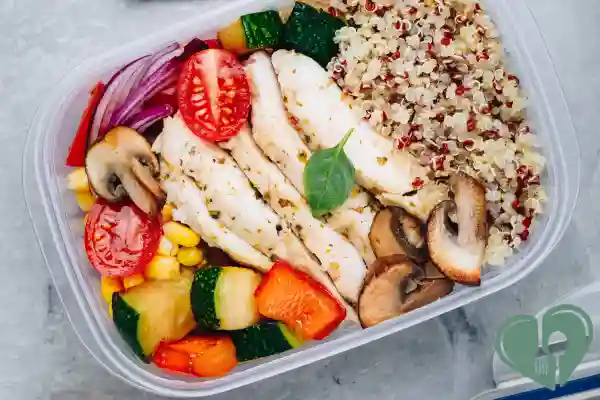 Diabetic-friendly meal prep container with grilled chicken, quinoa, and assorted colorful vegetables
