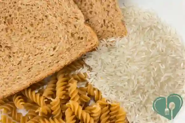 A close-up of traditional carb staples: white rice, pasta, and whole wheat bread
