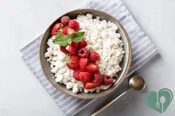 Cottage cheese bowl topped with strawberries, raspberries, and mint