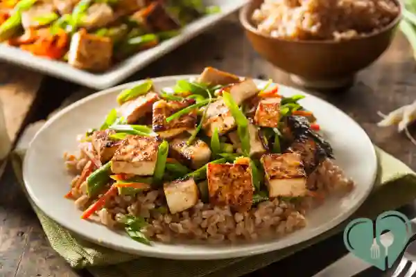 Grilled tofu stir-fry with vegetables over brown rice