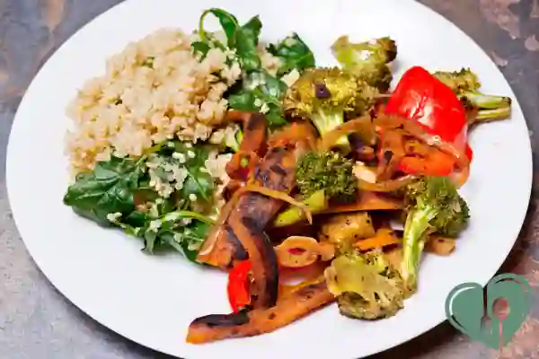 Plate of stir-fried vegetables with quinoa and leafy greens — a quick diabetic pantry meal.