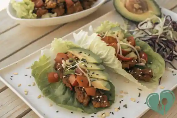Tempeh tacos served in lettuce wraps with avocado, cabbage, and sesame seeds — low-carb and diabetic-friendly