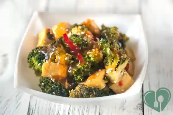 Diabetic-friendly tofu stir-fry with broccoli and sesame sauce served in a white bowl