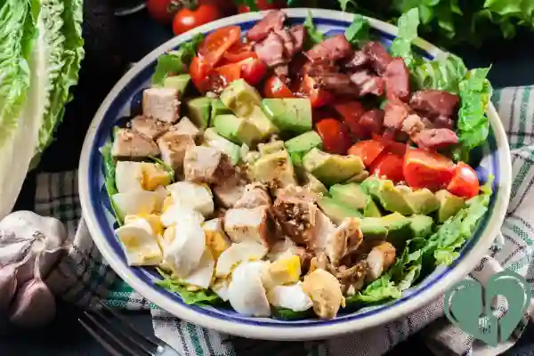 Colorful diabetic-friendly Cobb salad with eggs, chicken, avocado, tomatoes, and lean beef on a bed of lettuce