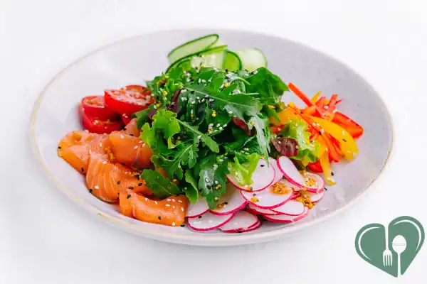 Low-carb diabetic-friendly lunch with salmon, radish, cucumber, and leafy greens