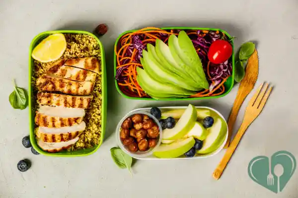 Balanced diabetic lunchbox with grilled chicken, avocado salad, apple slices, blueberries, and roasted chickpeas