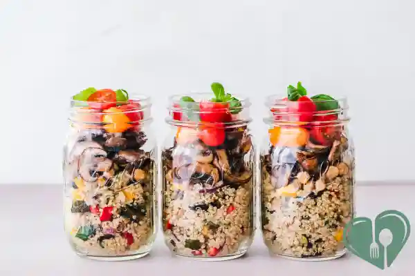 Mason jar salads with quinoa, chickpeas, roasted vegetables, mushrooms, and cherry tomatoes – diabetic-friendly meal prep