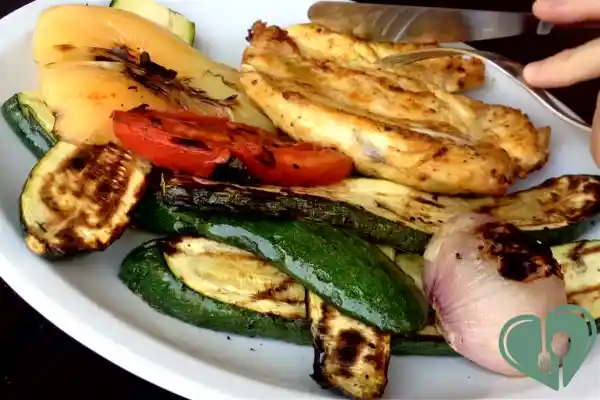 Grilled chicken breast served with assorted grilled vegetables including zucchini, bell pepper, tomato, and onion — diabetic-friendly lunch