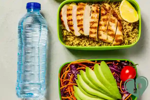 Diabetic-friendly meal prep with grilled chicken, quinoa, avocado salad, and water bottle
