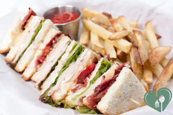 Unhealthy fast lunch with white bread sandwich and fries that can spike blood sugar