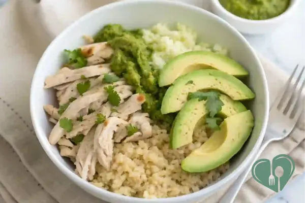 Low-carb salsa verde chicken bowl with cauliflower rice, avocado slices, and cilantro - a fresh and diabetic-friendly crockpot meal.