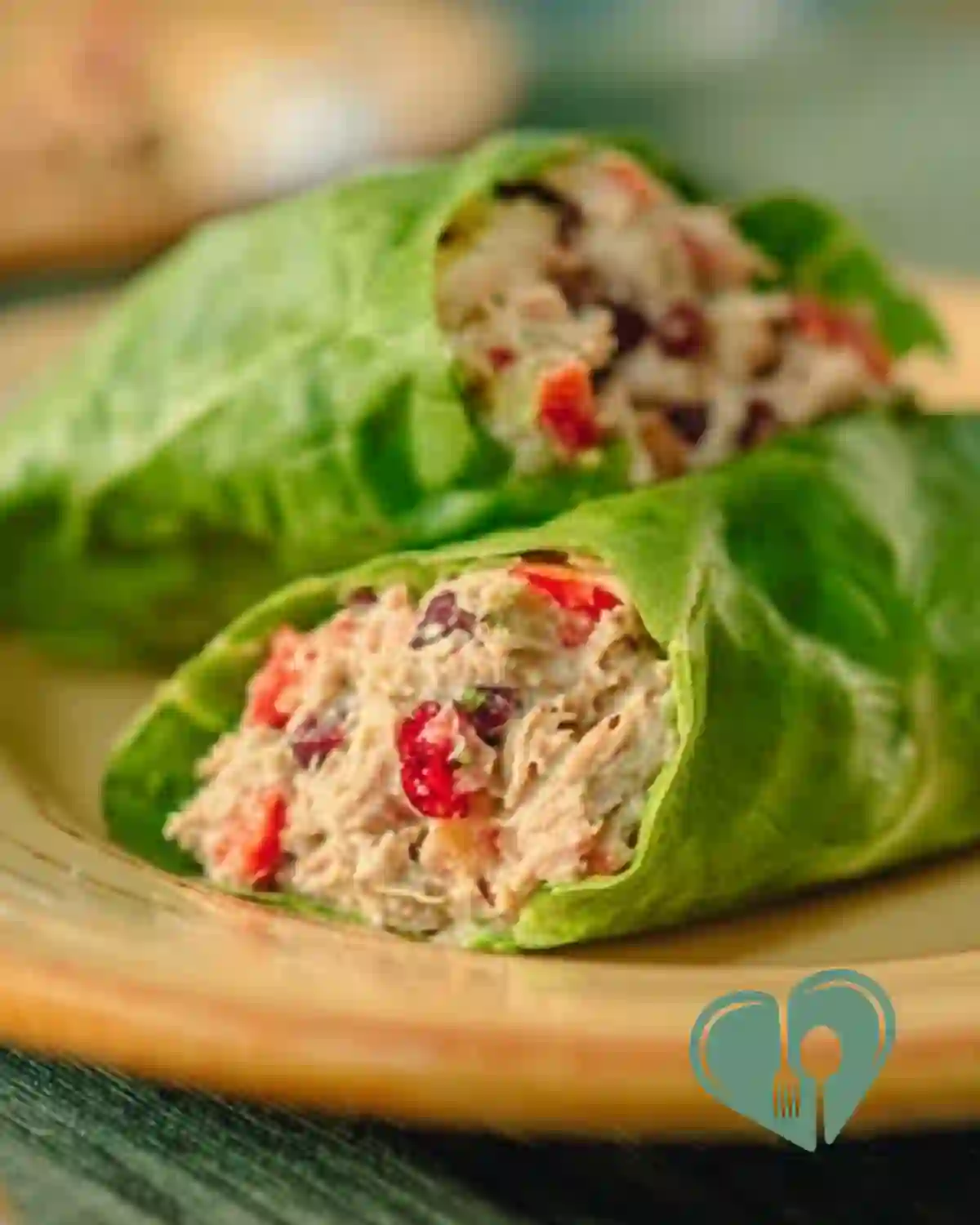 Mediterranean tuna salad wraps with crunchy vegetables and herbs, served on a wooden table