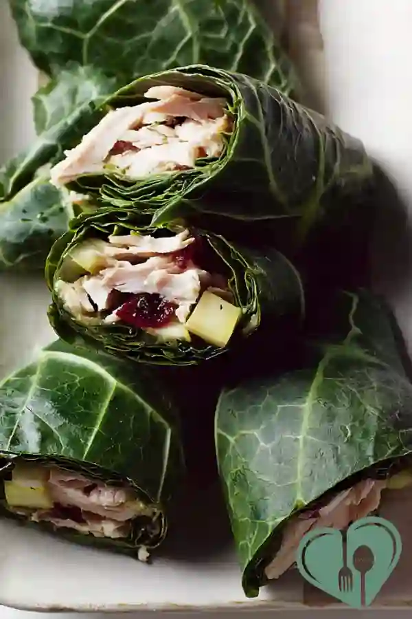 Kale turkey wraps with fresh greens served on a wooden table