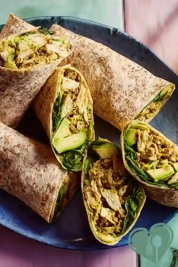 Turmeric chicken avocado wraps with soft tortilla and fresh ingredients on a plate