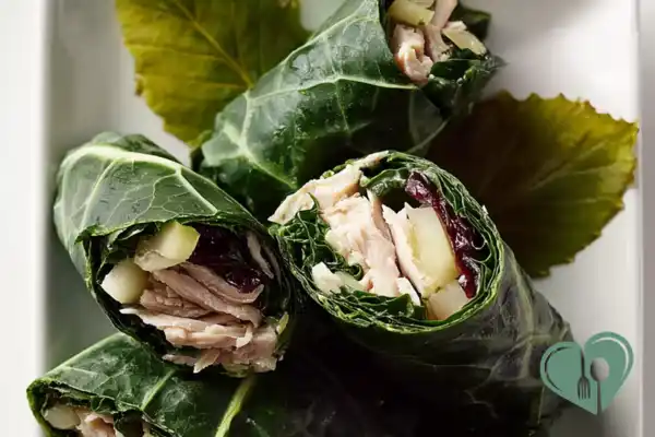 Kale turkey wraps with fresh greens in a soft tortilla on a simple plate