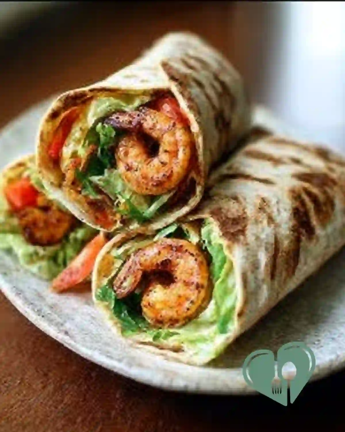 Thai shrimp wraps with grilled tortillas, fresh vegetables, and peanut sauce on a plate